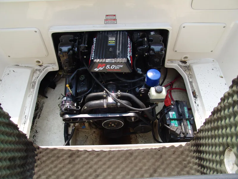 Slide: The Image of Engine compartment of 2000 Sea Ray 215 Express Cruiser with 5.0L Mercury engine. - 19