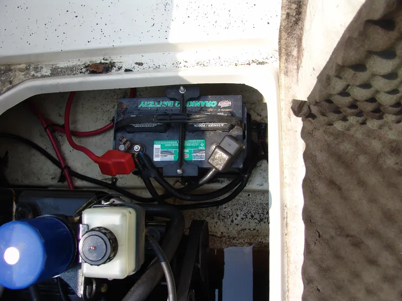 Slide: The Image of Battery compartment of a 2000 Sea Ray 215 Express Cruiser with visible wiring and components. - 21