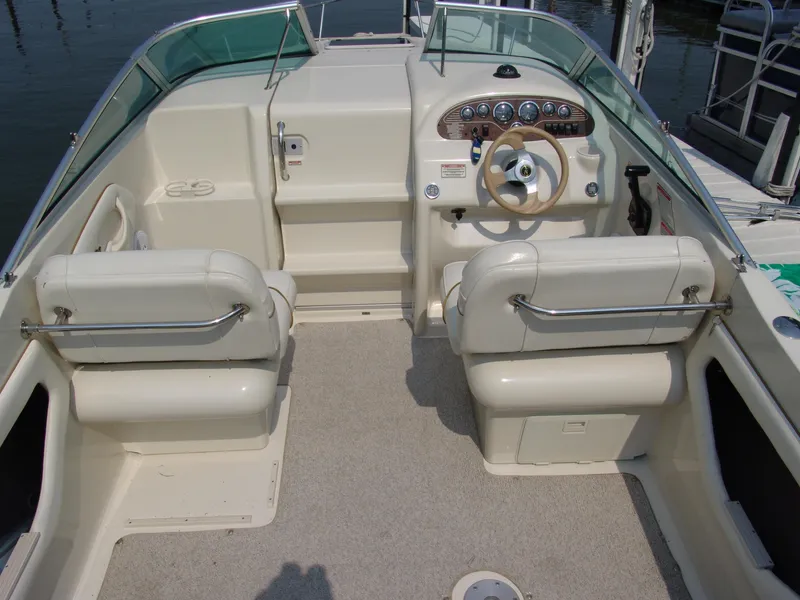 Slide: The Image of 2000 Sea Ray 215 Express Cruiser interior with dual seats and steering console. - 6