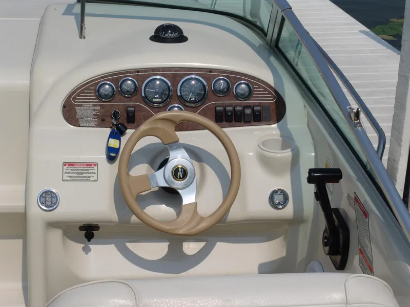 Slide: The Image of 2000 Sea Ray 215 Express Cruiser dashboard with steering wheel and instrument panel. - 7