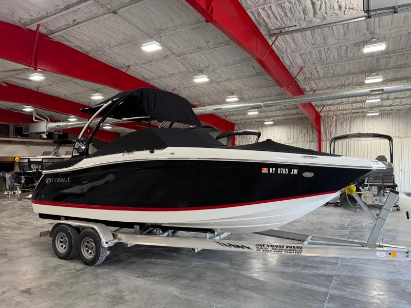 Slide: The Image of 2015 Cobalt 24 SD boat on trailer in indoor storage facility. - 13