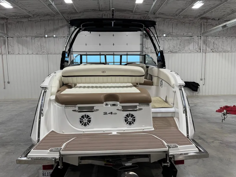 Slide: The Image of 2015 Cobalt 24 SD boat in a garage, featuring a spacious rear deck and seating. - 5