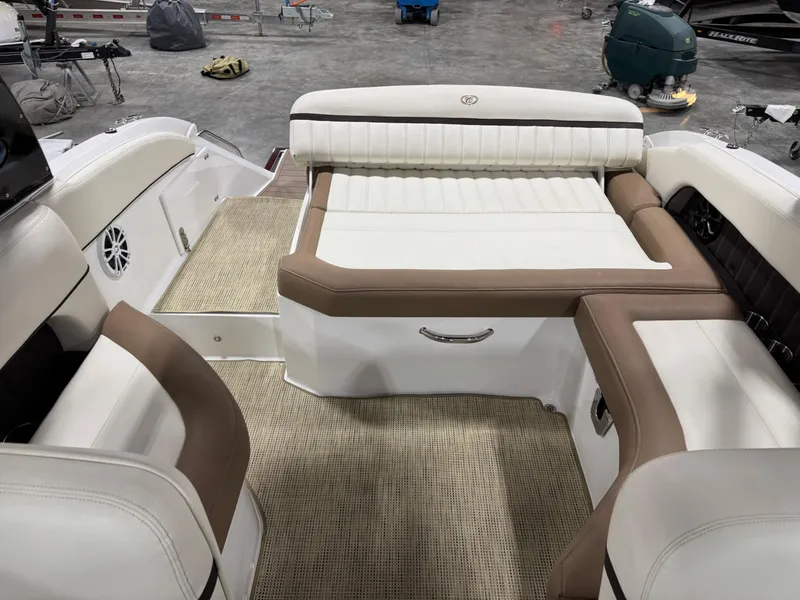 Slide: The Image of 2015 Cobalt 24 SD boat interior with beige and white seating, spacious layout. - 8