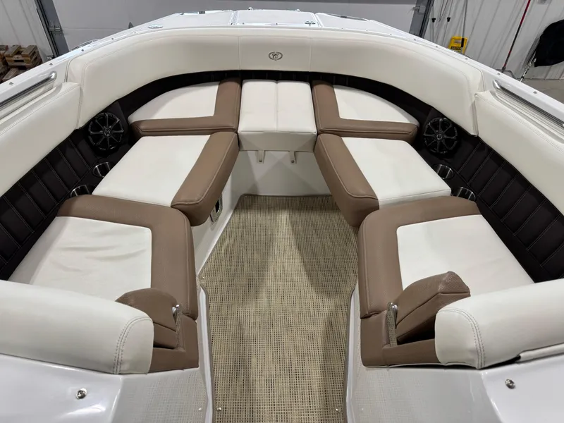 Slide: The Image of 2015 Cobalt 24 SD boat interior with white and brown seating arrangement. - 9