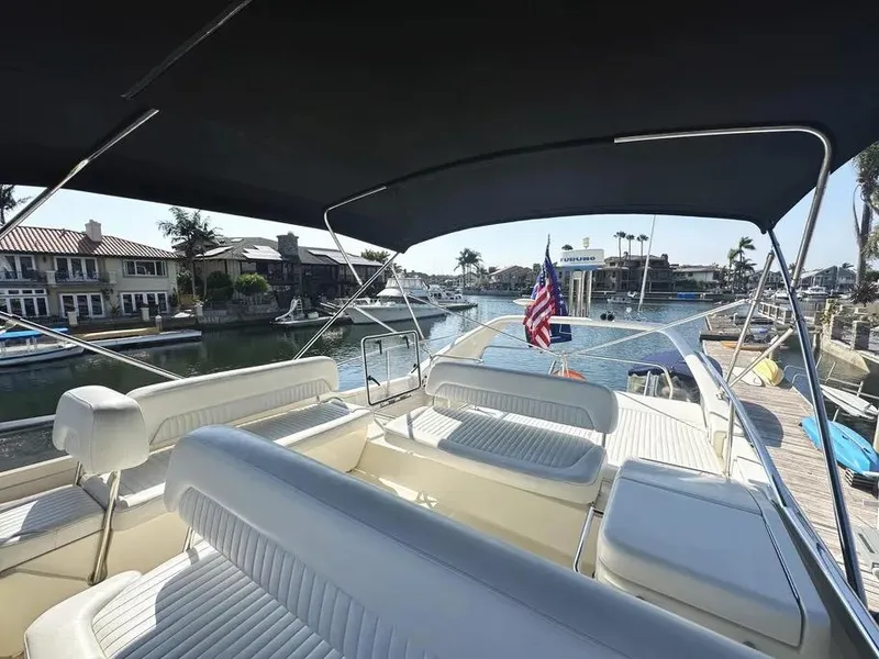 Slide: The Image of Flybridge view of 1996 Azimut 54 yacht docked in a scenic marina. - 16