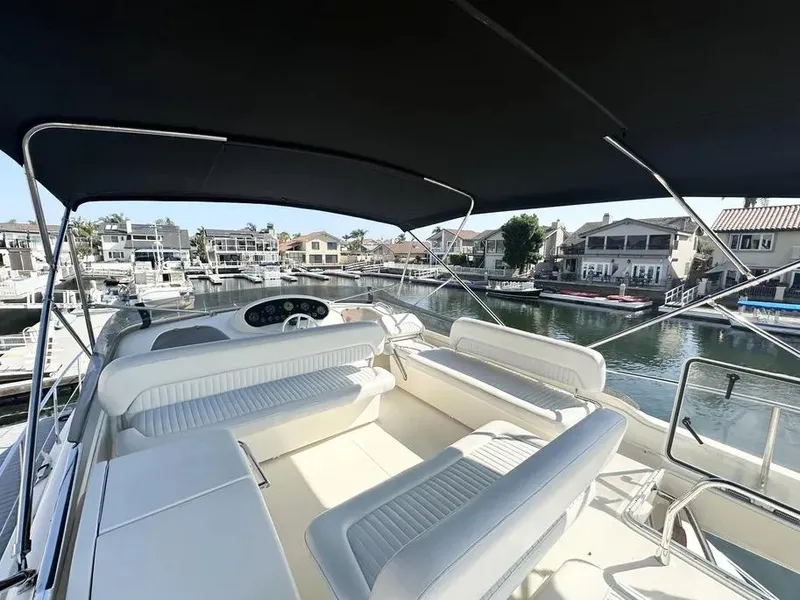 Slide: The Image of Flybridge of 1996 Azimut 54 yacht with seating, overlooking marina and waterfront homes. - 18