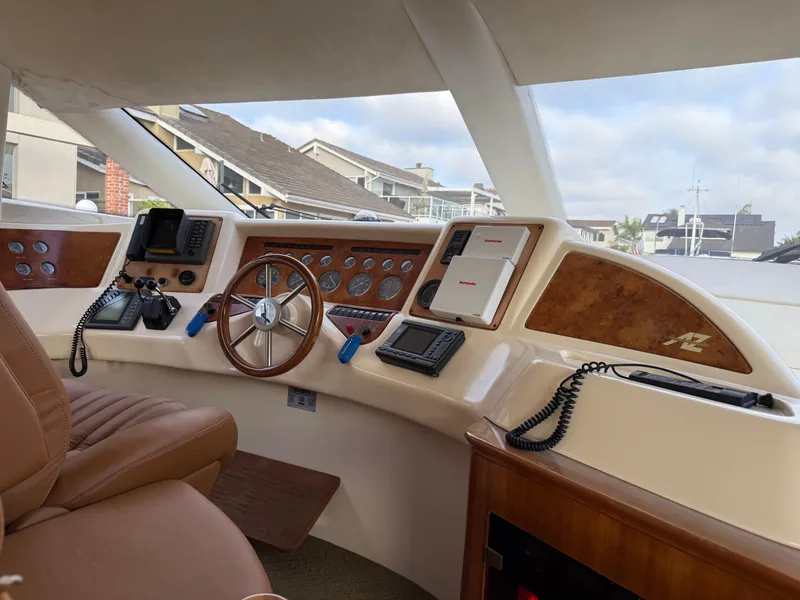 Slide: The Image of Interior view of 1996 Azimut 54 yacht helm with steering wheel and navigation equipment. - 23