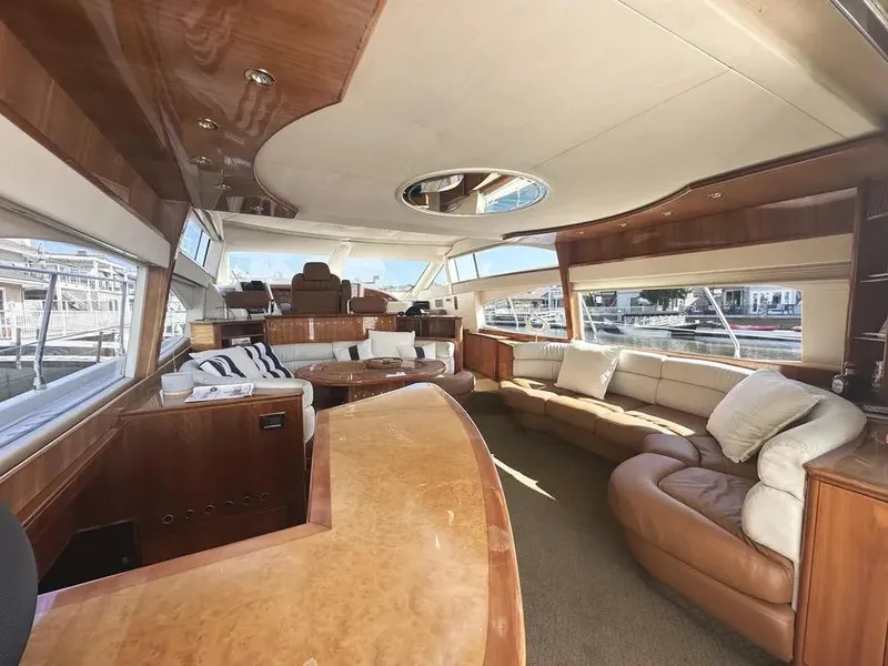 Slide: The Image of Luxurious interior of a 1996 Azimut 54 yacht with elegant wood finishes and plush seating. - 26
