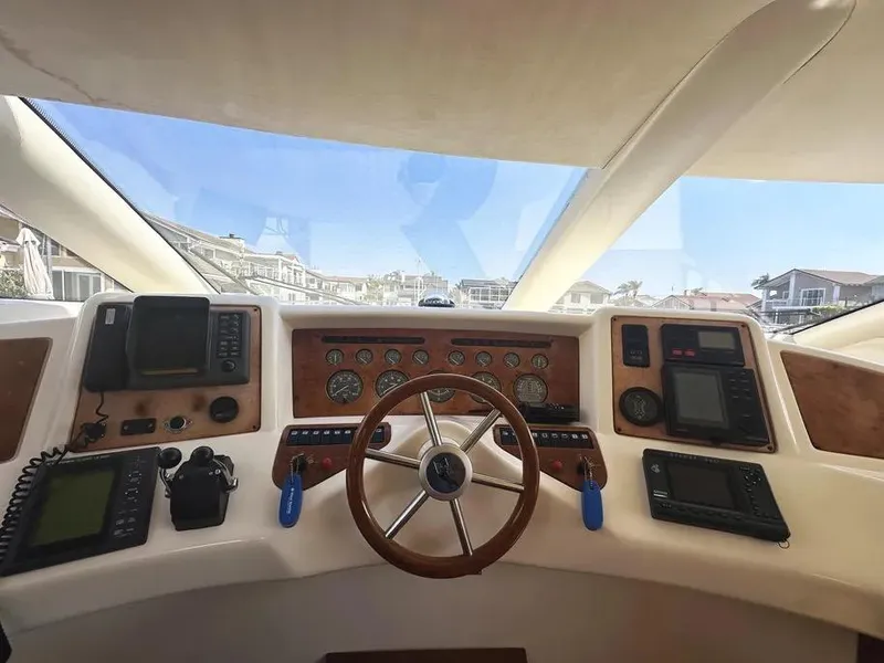Slide: The Image of Interior view of 1996 Azimut 54 yacht cockpit with steering wheel and navigation instruments. - 28