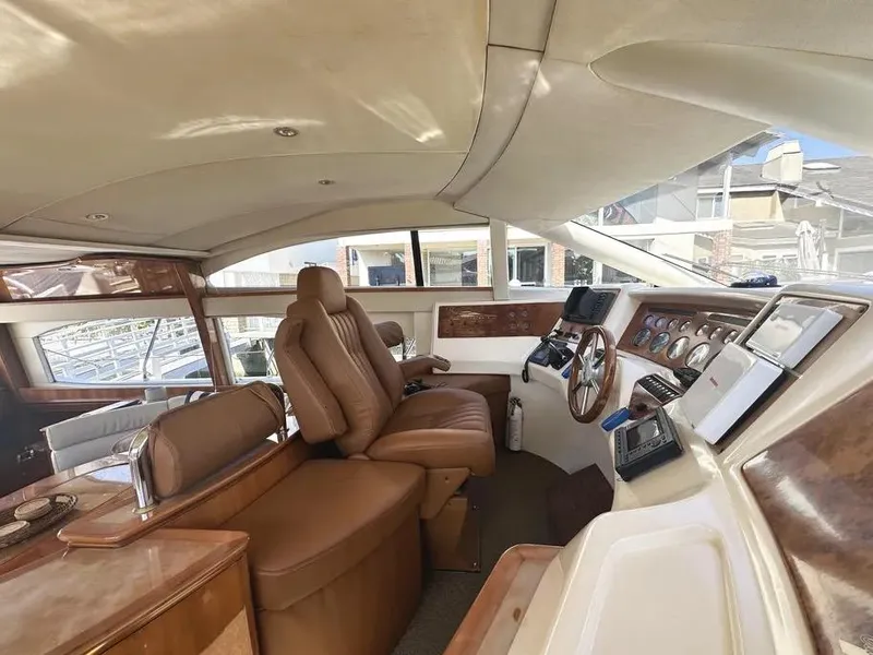 Slide: The Image of Interior of a 1996 Azimut 54 yacht with luxurious leather seating and wooden dashboard. - 32