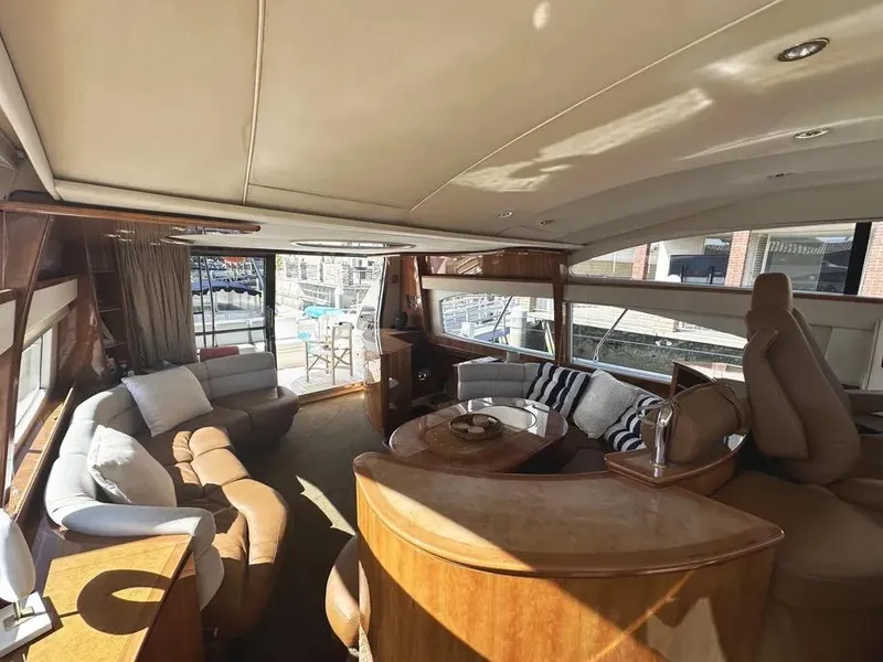 Slide: The Image of Luxurious interior of a 1996 Azimut 54 yacht with elegant seating and panoramic windows. - 34