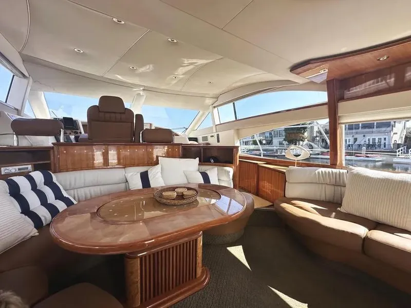 Slide: The Image of Luxurious interior of a 1996 Azimut 54 yacht with elegant seating and panoramic windows. - 36