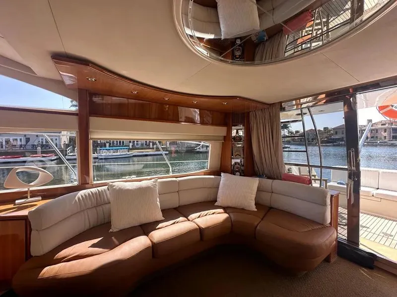 Slide: The Image of Luxurious interior of a 1996 Azimut 54 yacht with plush seating and waterfront view. - 37