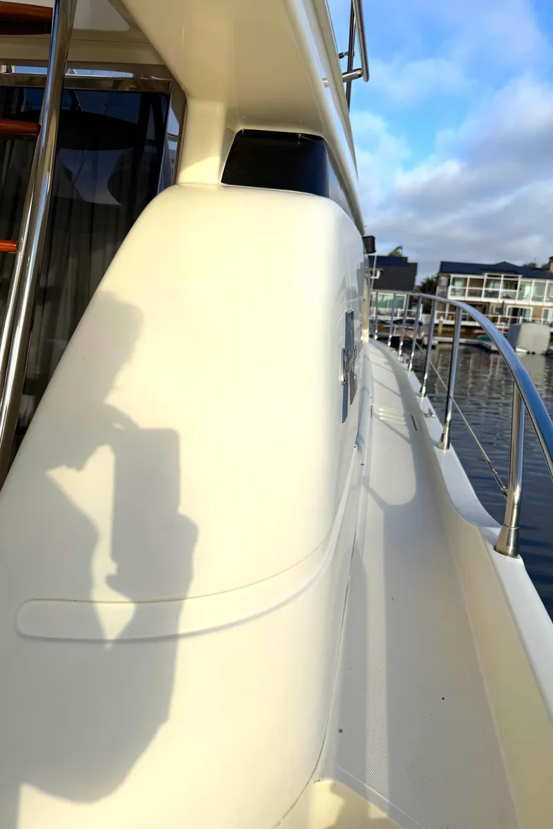Slide: The Image of Side view of 1996 Azimut 54 yacht with railing and water reflection. - 4