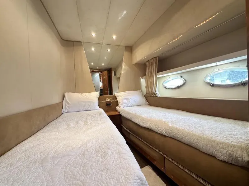 Slide: The Image of Interior of 1996 Azimut 54 yacht with twin beds and porthole windows. - 41