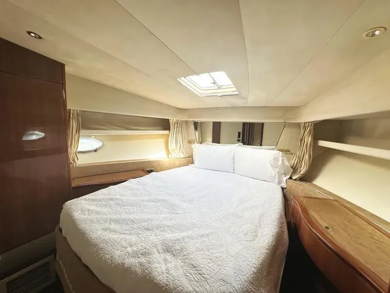Slide: The Image of Luxurious bedroom interior of a 1996 Azimut 54 yacht with elegant bedding and wood accents. - 44