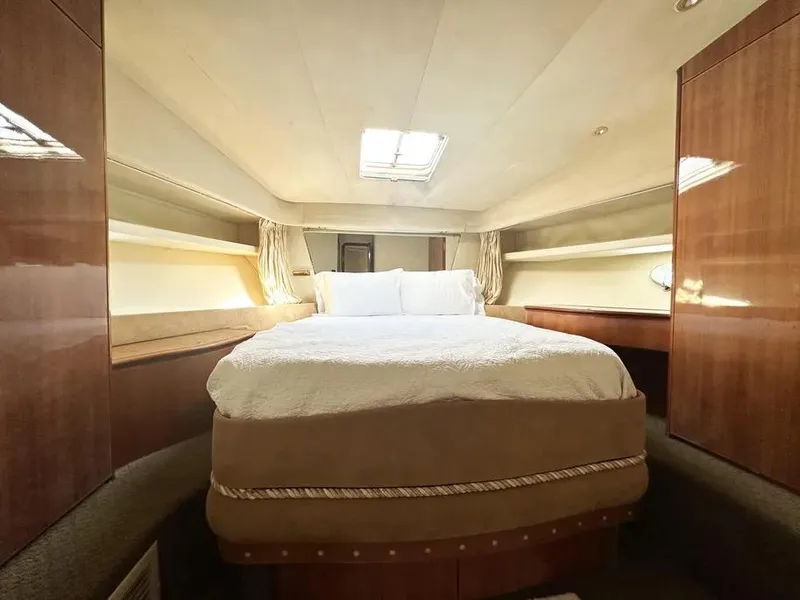 Slide: The Image of Luxurious bedroom interior of a 1996 Azimut 54 yacht with elegant wood finishes. - 45