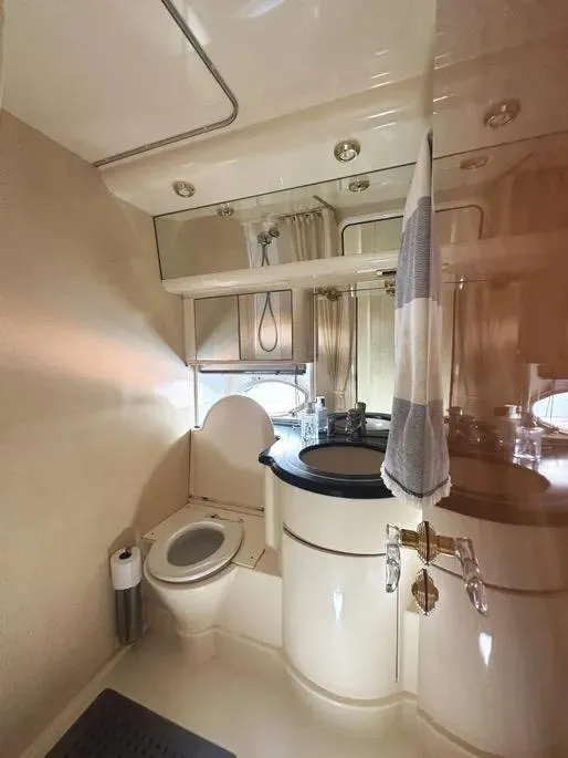 Slide: The Image of Bathroom interior of a 1996 Azimut 54 yacht, featuring a toilet and sink. - 47
