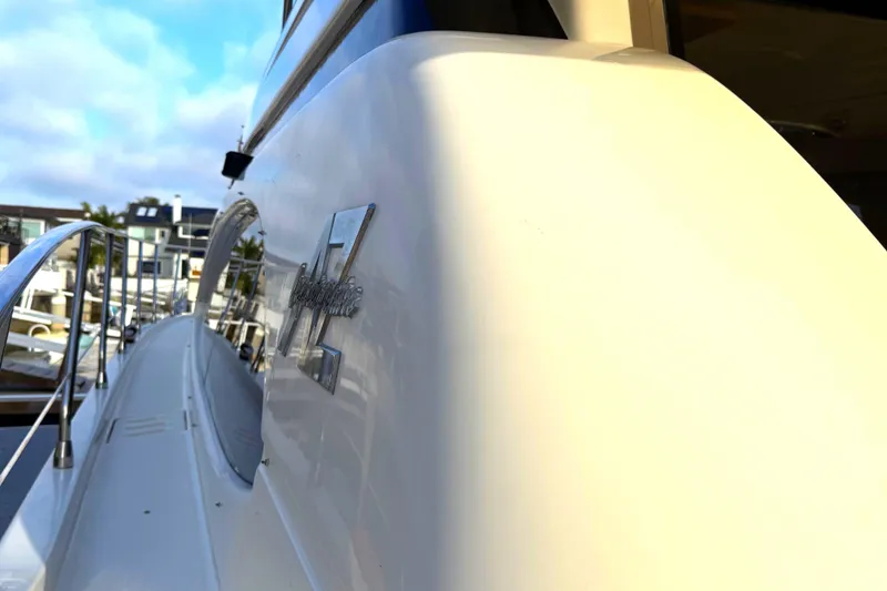 Slide: The Image of 1996 Azimut 54 yacht side view with sleek design and marina background. - 5