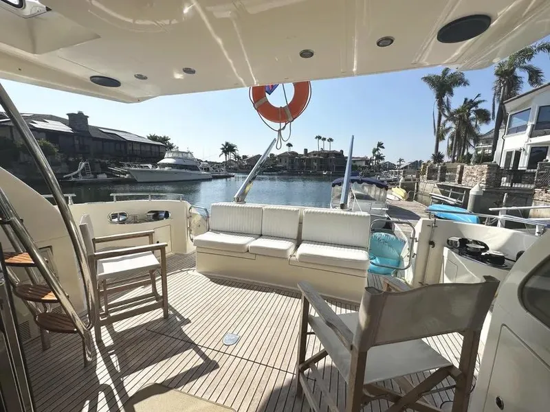 Slide: The Image of Spacious deck of a 1996 Azimut 54 yacht, docked in a sunny marina. - 7