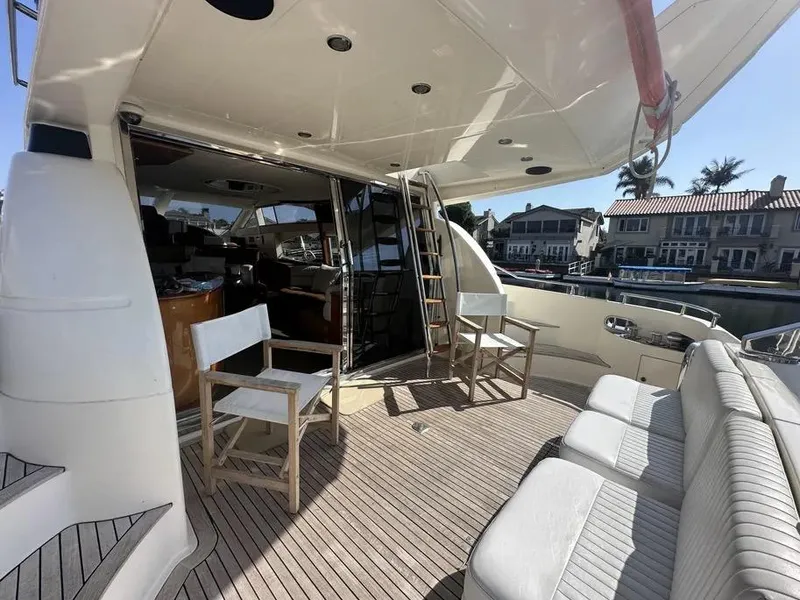 Slide: The Image of Luxury 1996 Azimut 54 yacht deck with seating and waterfront view. - 9