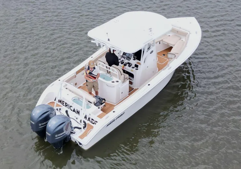 Slide: The Image of 2023 Sea Pro 259 DLX boat on water, featuring dual Yamaha engines. - 10