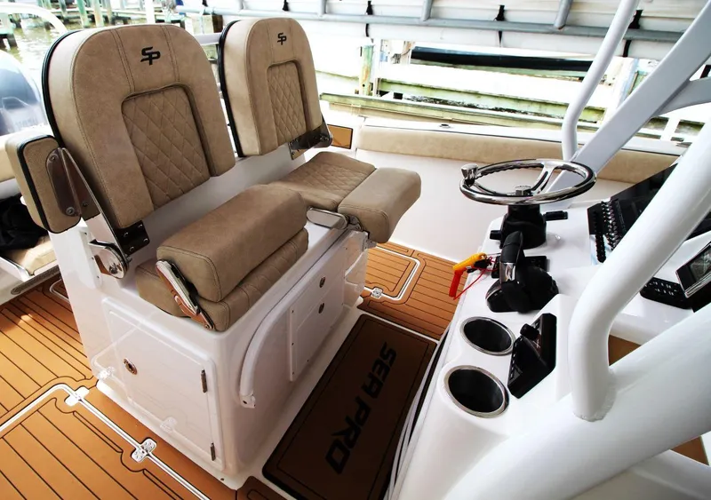 Slide: The Image of 2023 Sea Pro 259 DLX boat interior with dual seats and steering console. - 15