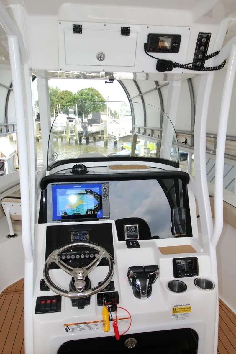 Slide: The Image of 2023 Sea Pro 259 DLX boat dashboard with modern navigation and control systems. - 16