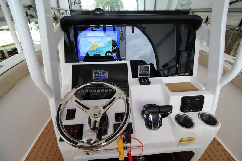 Slide: The Image of 2023 Sea Pro 259 DLX boat dashboard with navigation system and controls. - 17
