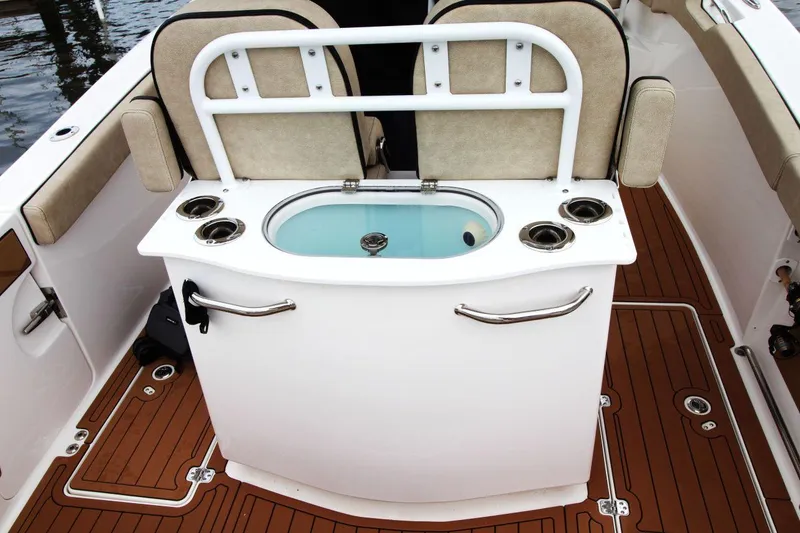 Slide: The Image of 2023 Sea Pro 259 DLX boat interior with livewell and seating. - 18