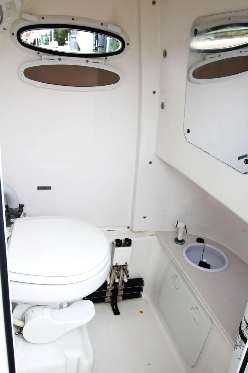 Slide: The Image of 2023 Sea Pro 259 DLX boat interior with toilet and sink. - 19