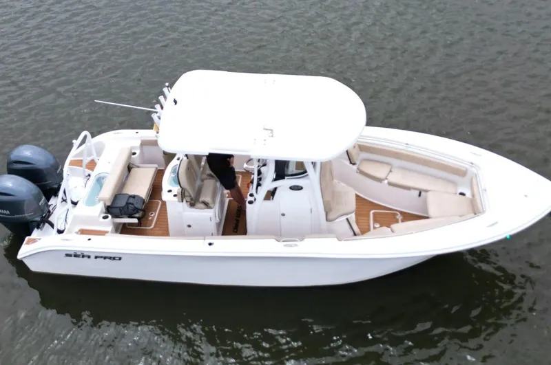 Slide: The Image of 2023 Sea Pro 259 DLX boat on water, featuring dual engines and spacious seating. - 7