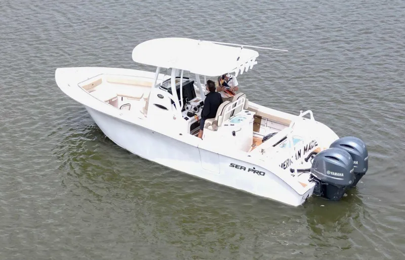 Slide: The Image of 2023 Sea Pro 259 DLX boat on water with dual Yamaha engines. - 8
