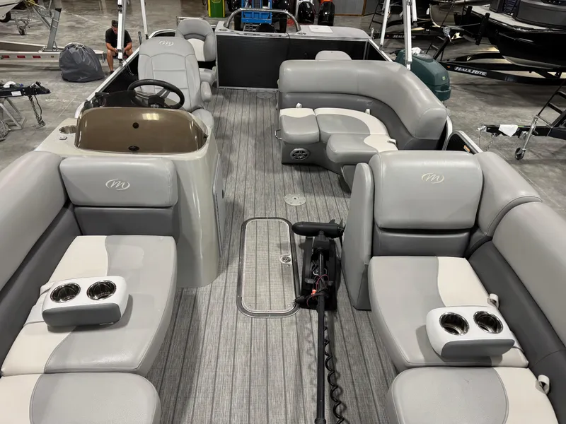 Slide: The Image of 2018 Manitou 23 Aurora LE pontoon boat interior with gray seating and cup holders. - 11