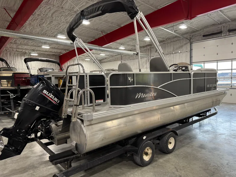 Slide: The Image of 2018 Manitou 23 Aurora LE pontoon boat with Suzuki outboard motor in a showroom. - 3