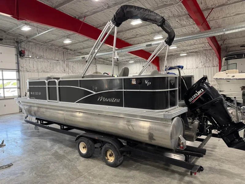 Slide: The Image of 2018 Manitou 23 Aurora LE pontoon boat with Suzuki outboard motor in a warehouse. - 4