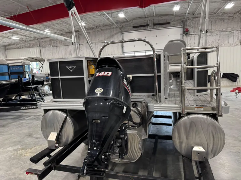 Slide: The Image of 2018 Manitou 23 Aurora LE pontoon boat with Suzuki 140 outboard motor in a showroom. - 5