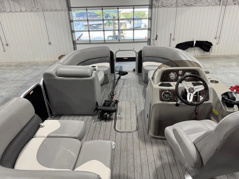Slide: The Image of 2018 Manitou 23 Aurora LE pontoon boat interior with gray seating and steering console. - 7