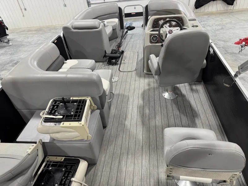 Slide: The Image of 2018 Manitou 23 Aurora LE pontoon boat interior with gray seating and steering console. - 8