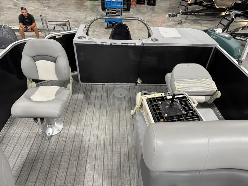 Slide: The Image of 2018 Manitou 23 Aurora LE pontoon boat interior with seating and steering console. - 9