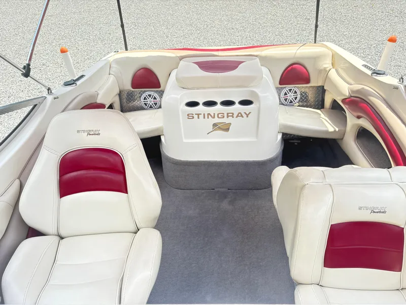Slide: The Image of 1999 Stingray 190 LS boat interior with white and red seating, cup holders, and speakers. - 13