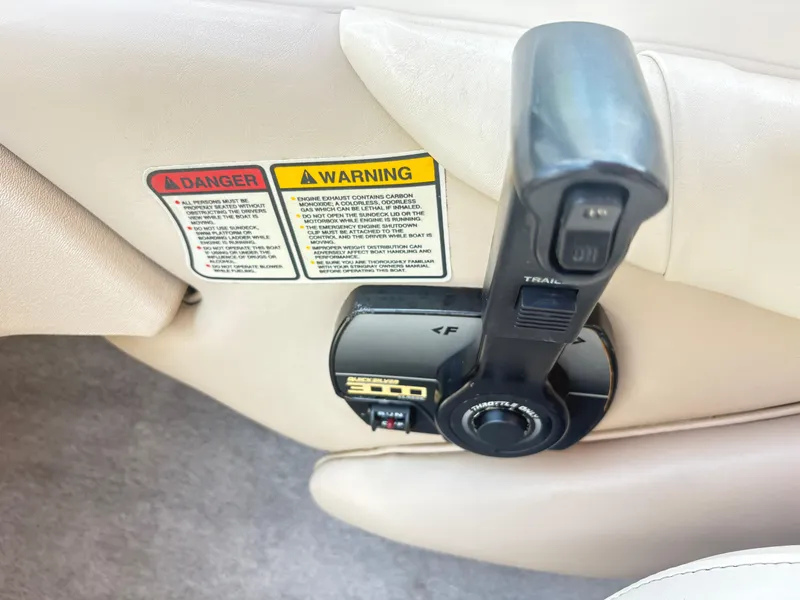 Slide: The Image of Throttle control and warning labels on a 1999 Stingray 190 LS boat. - 16