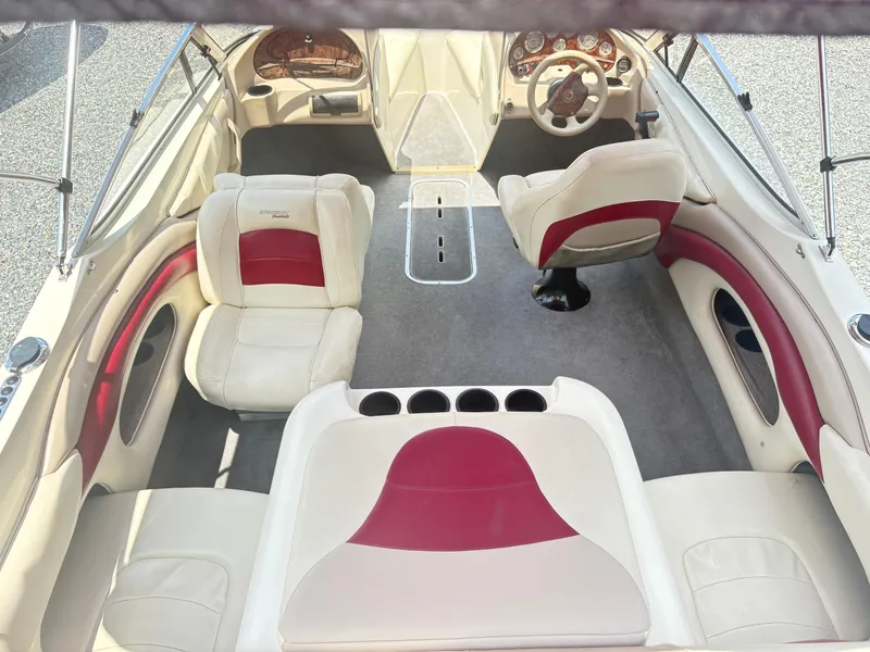 Slide: The Image of 1999 Stingray 190 LS boat interior with white and red seating, steering wheel, and dashboard. - 7