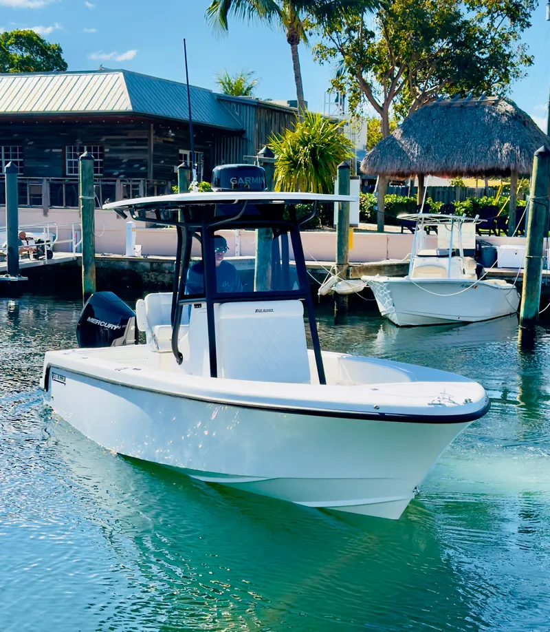 Slide: The Image of 2026 Reef Runner 230 C Open boat in harbor. - 28