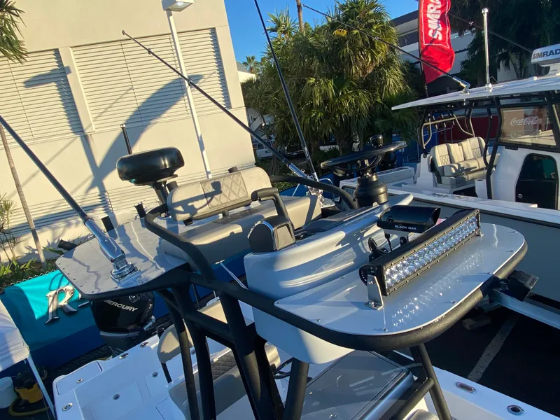 Slide: The Image of Reef Runner 230 C Open 2026 on calm waters under blue sky. - 3