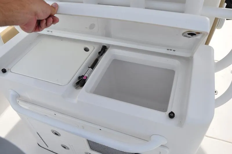 Slide: The Image of 2017 Sportsman Open 282 Center Console storage compartment with open lid. - 10
