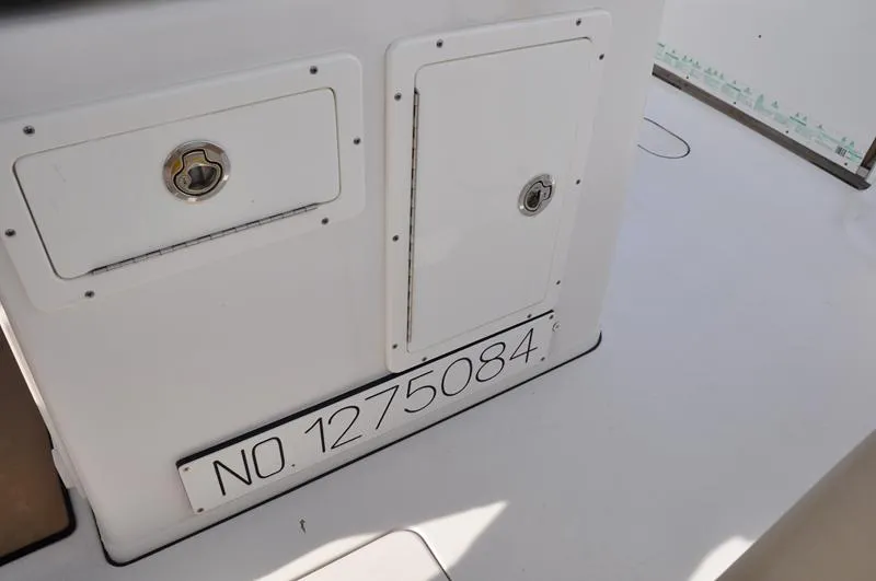 Slide: The Image of 2017 Sportsman Open 282 Center Console boat with storage compartments and registration number. - 18