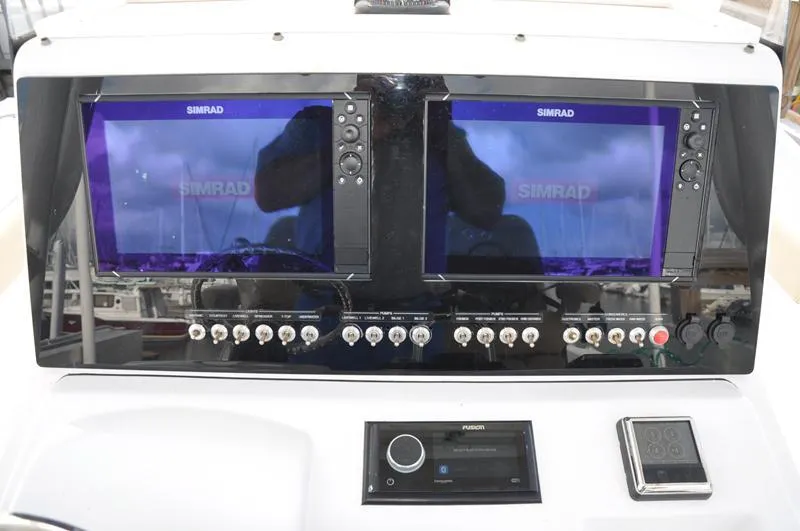 Slide: The Image of 2017 Sportsman Open 282 Center Console dashboard with dual Simrad displays. - 19