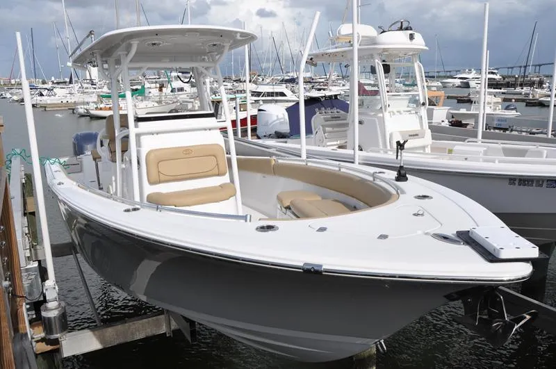 Slide: The Image of 2017 Sportsman Open 282 Center Console boat docked in a marina. - 2
