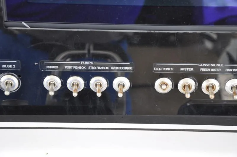 Slide: The Image of Control panel of a 2017 Sportsman Open 282 Center Console boat with labeled switches. - 24